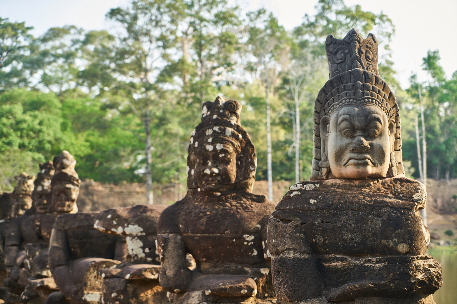 Stone temple figures in a tropical landscape
